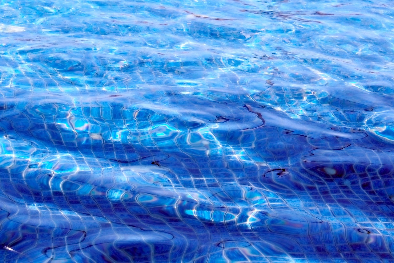 Pool builders working on a backyard pool in Gilbert, AZ